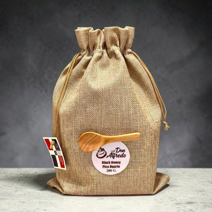 Hessian drawstring bag with a wooden spoon and label on a gray background